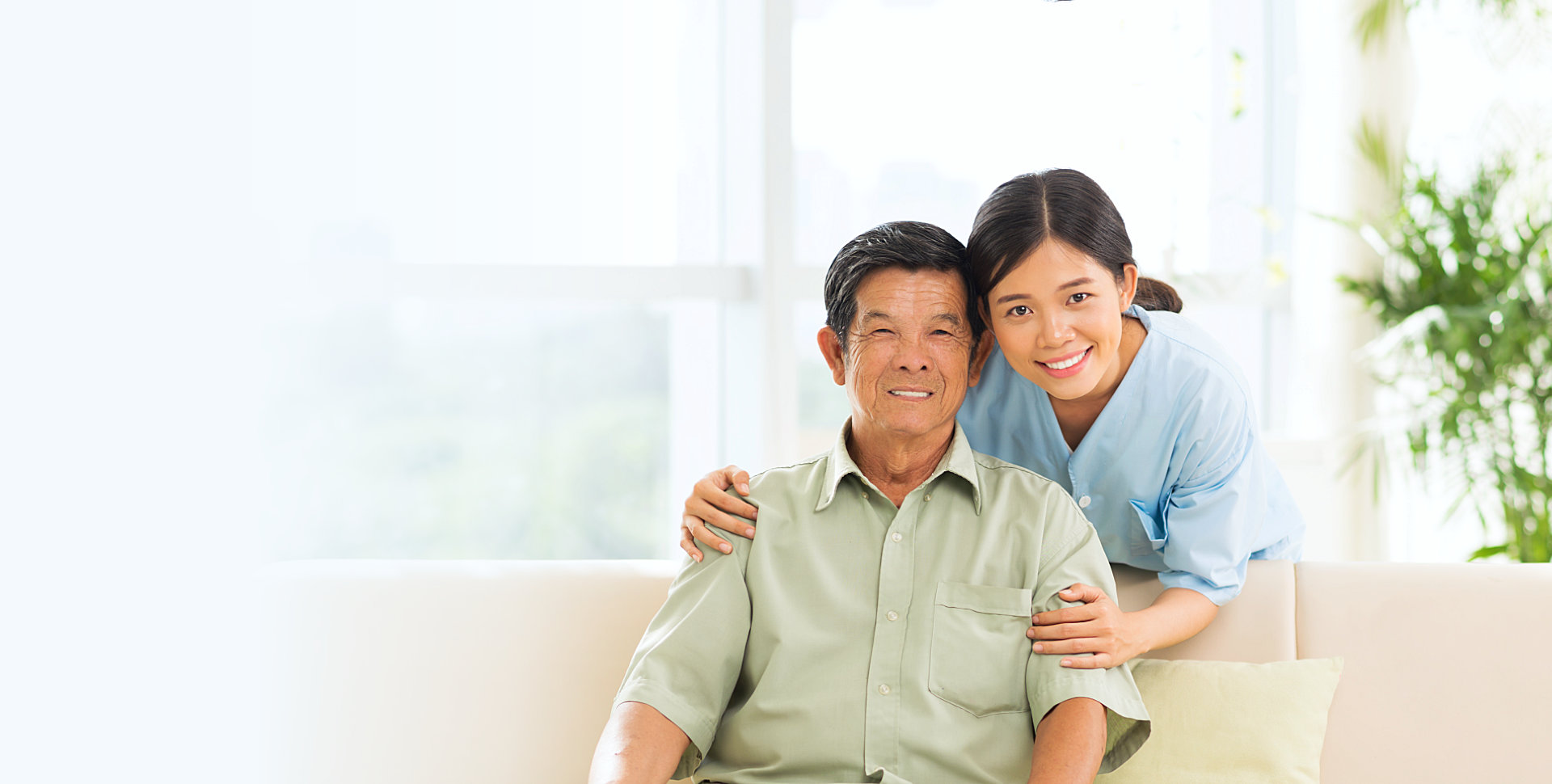 caregiver hugging senior man