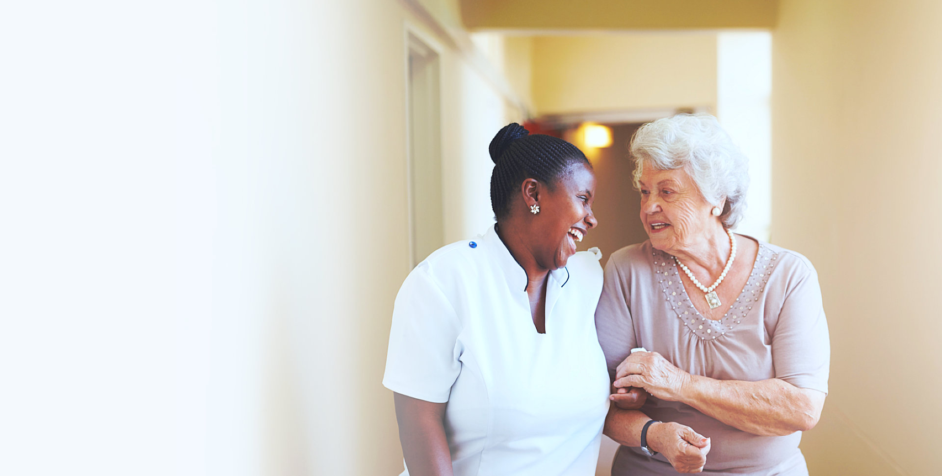 caregiver and senior woman walking while talking